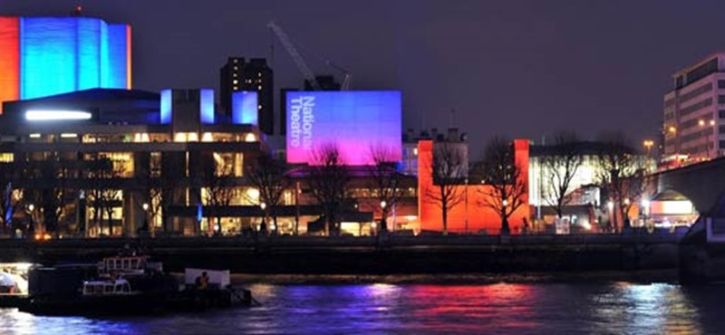 A photo of the National Theatre at night.