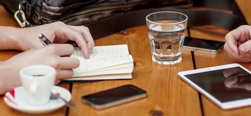 Image of people working with a tablet and a phone.